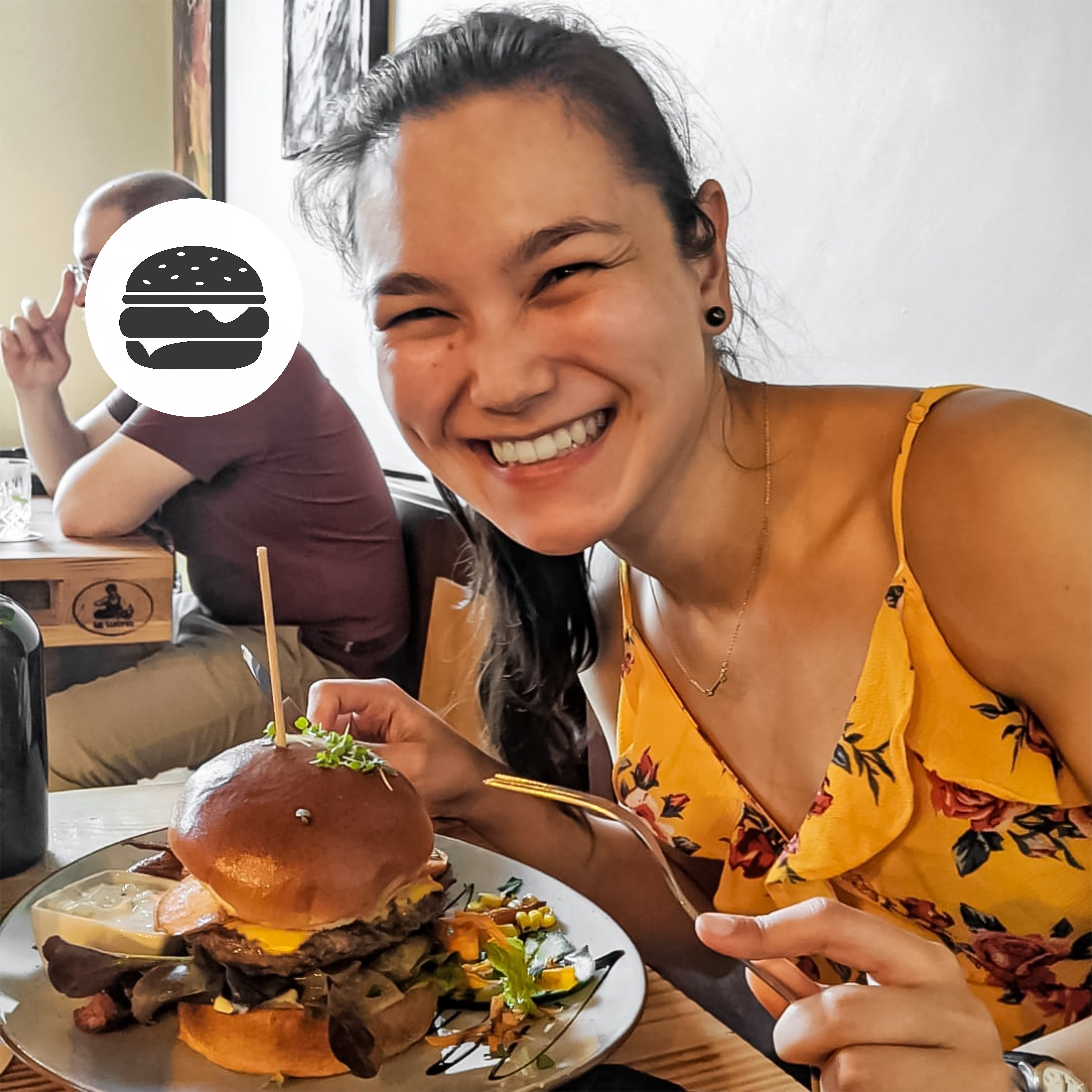 Angelina Fischer smiling over a burger
